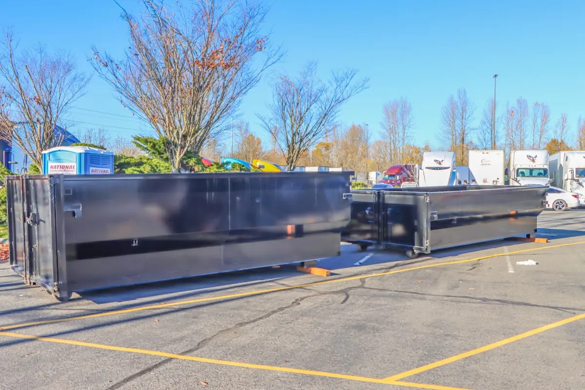 Professional dumpster rental service with roll-off container on residential driveway in Northborough